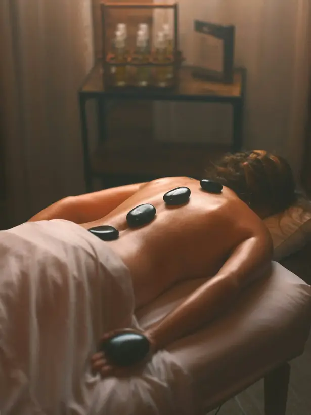 Hot stones arranged beside the massage table